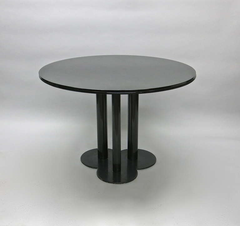 Dining table with a black enameled base, called Trifoglio for three leaf, that supports a, rounded edged bronze tinted, glass top Designed in 1969 by 
Sergio Asti for poltronova