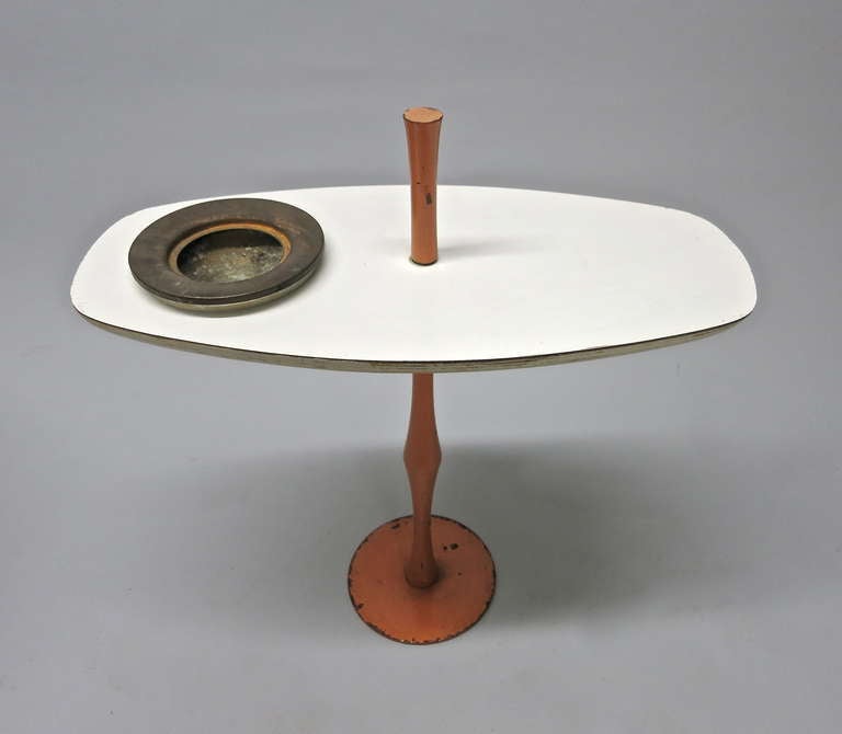 Table with hand-painted metal stand that supports a laminate top notched to hold an ashtray.