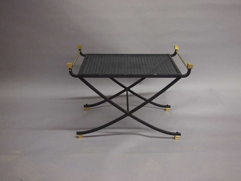 Bench in enameled black metal with solid brass detail and a mesh seat