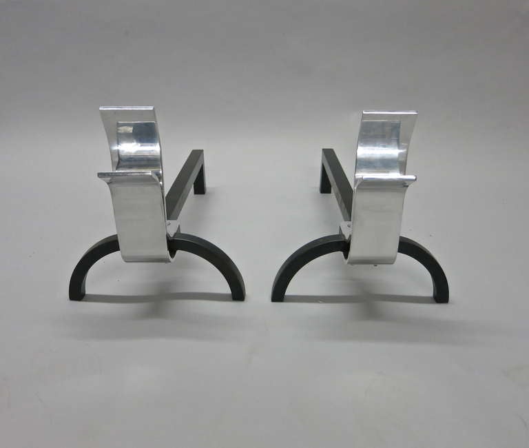 Pair of andirons with polished steel detailed of two arches and wrought iron curved legs and back