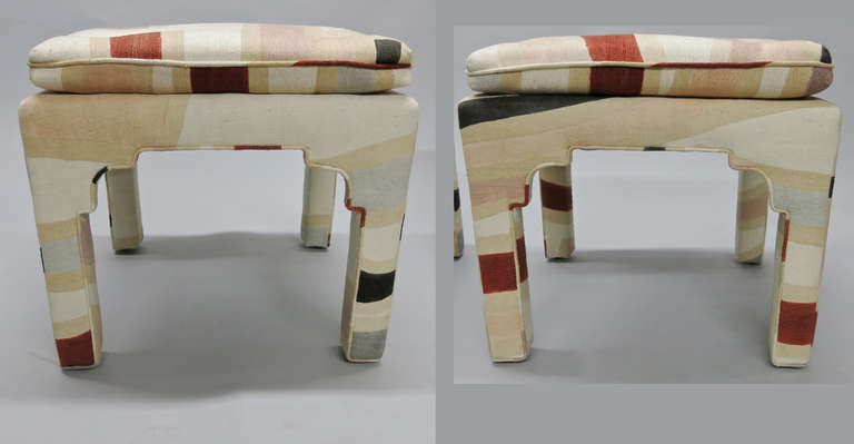 Pair of square stools upholstered in multi colored fabric. Both stool done in the same fabric but not the same repeat.