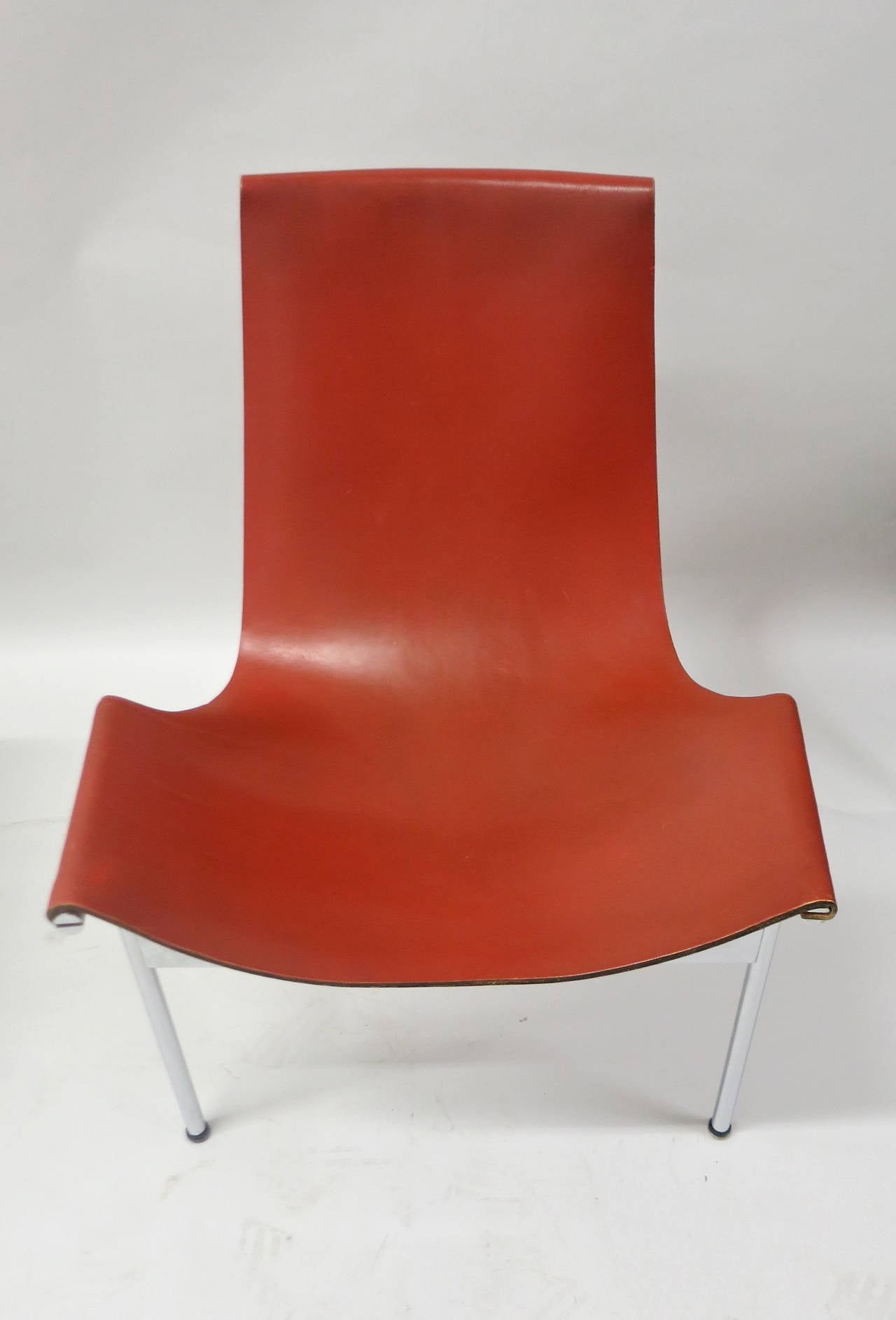 Rare set of ten T-chairs with special ordered leather backing in a matching tone as the front red-brown saddle leather. All have minimal wear and very careful use. The original condition is excellent and consistent on all ten. The