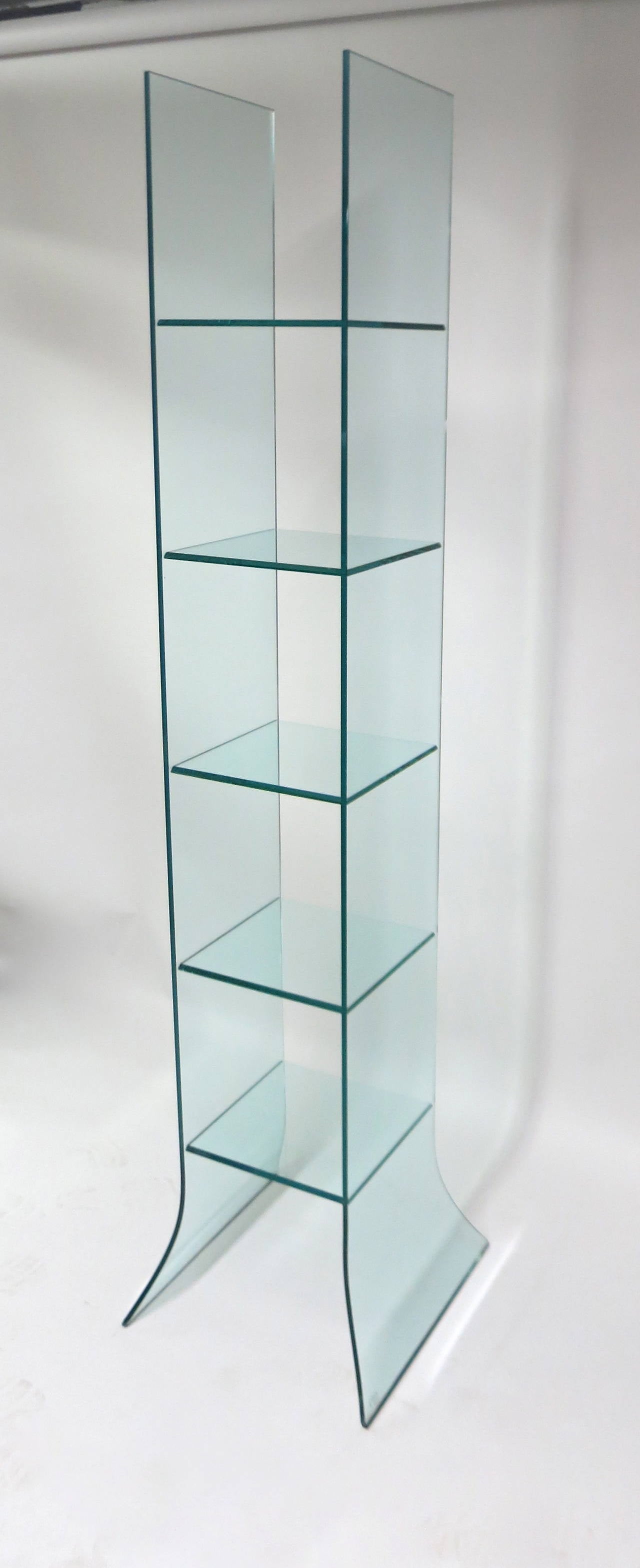 Tempered glass Shelving Unit designed in 1987 and produced by Fiam Italia. The unit has five beveled shelves that are supported on each side by the two vertical standing pieces of glass that flare at the bottom, making the unit sturdy,