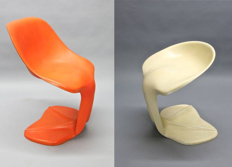 His and hers pair of unique sculptural chairs in orange and cream colored molded cast resin with a gel coat finish that has dulled over the years but no cracks, damages or repairs made to this rare pair of French designed and made chairs.