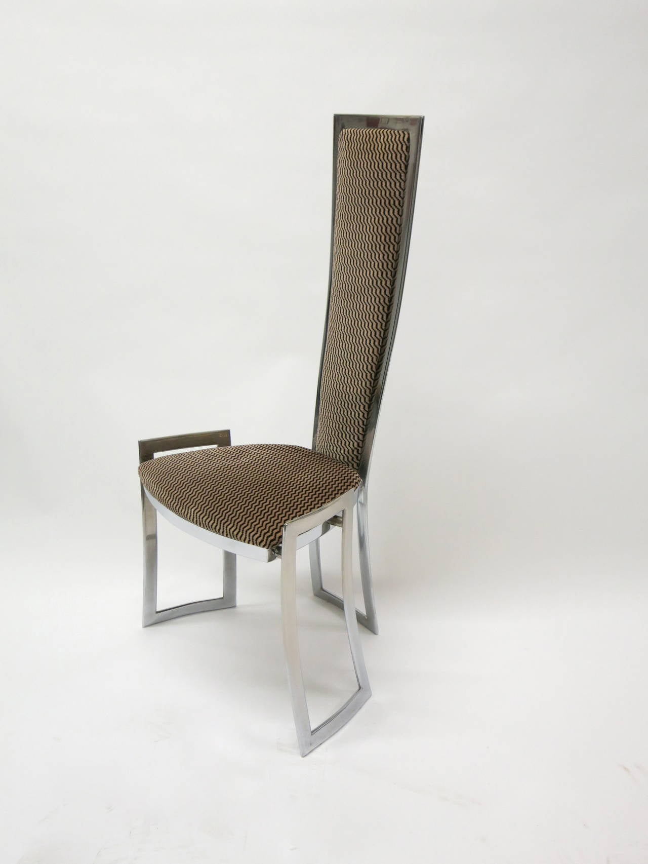 Set of 8 Dining chairs in with a polished steel frame with a rectangular support on each side and one in the back. The chairs are upholstered in a brown velvet fabric in very good condition.