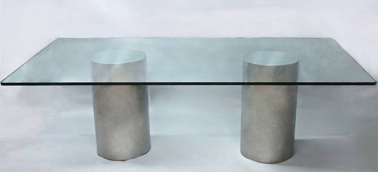 Dining table with a rectangular 3/4 inch glass top with rounded corners supported by two polished steel cylinders. The table seats eight to ten and was acquired from the original buyer who purchased it from Pace in the early 1980s.
