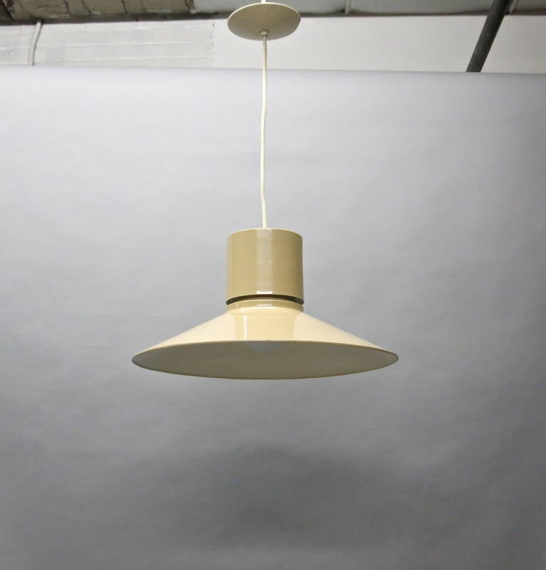 Four round ceiling fixtures in enameled metal each with a single socket and a top diffuser in perforated metal. Each light is supported by a single white wire that leads to the original labeled canopy.