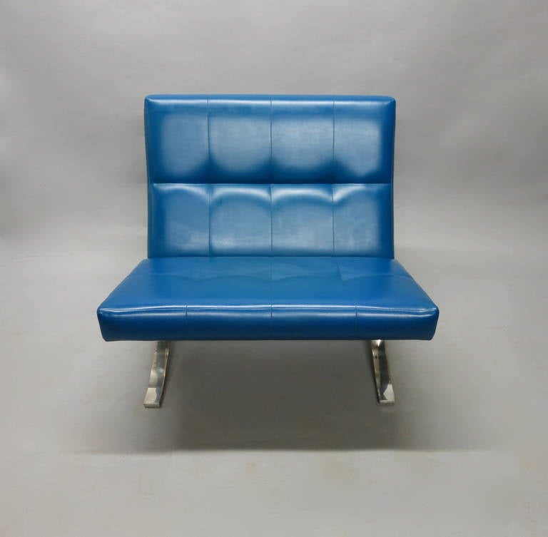 Pair of chairs with blue vinyl seat and back supported by a brushed Aluminum frame both have original labels that read J.G. Furniture Inc 156 east 56 st NYC.