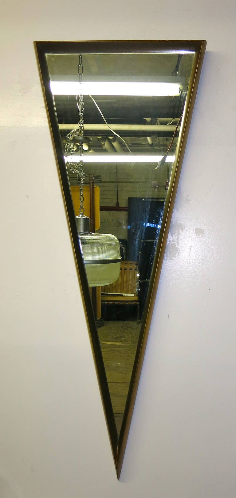 Triangular mirror framed in gold leafed 2-inch thick wood. The mirror can hang with the point up or down.
