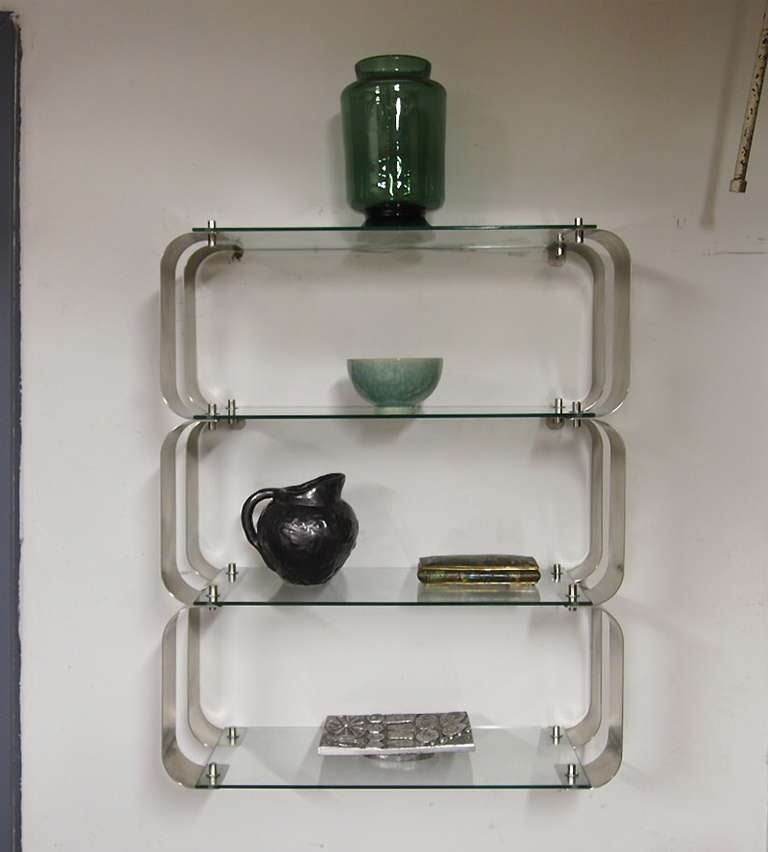 Shelving units by Monnet for Kappa in stainless steel and glass.
A simple design with very functional units that can be assembled and placed in different ways. Very sturdy. Each unit, as pictured, consists of three attached shelves that can be