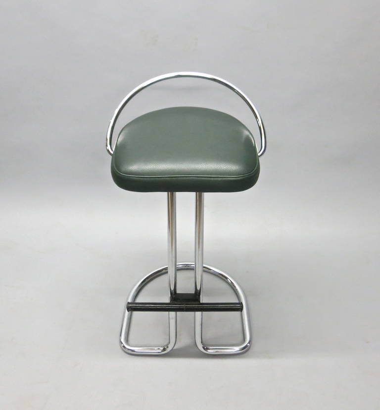 Three stools in tubular chrome with dark green leather seat and a black plastic over metal foot rest. All stools labeled Made in Italy label under seat on chrome.