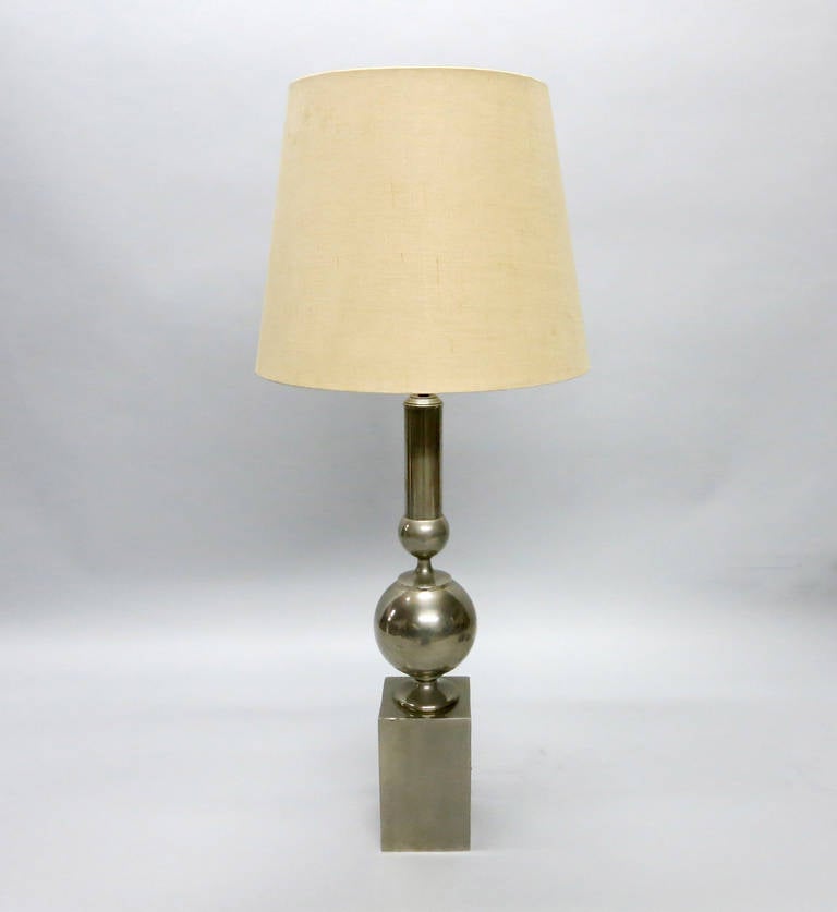 Tall table lamp in nickel plated steel the rectangular pedestal incorporated into the lamp was common of Barbier who designed tables and stools working with 
Henry Massonnet.