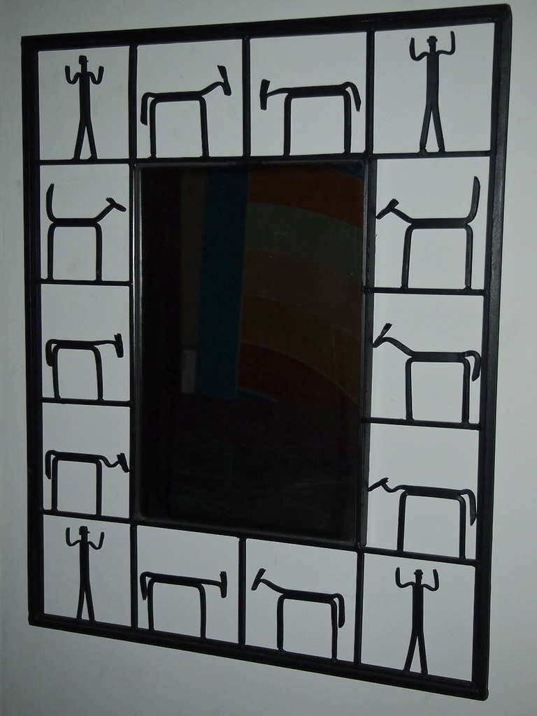 Rectangular Mirrored glass surrounded by black enameled wrought iron frame that is equally divided into 14 squares with a figure in each. figure. In each corners is a figure of a man and the other are of animals. 
Collectively, they give off the