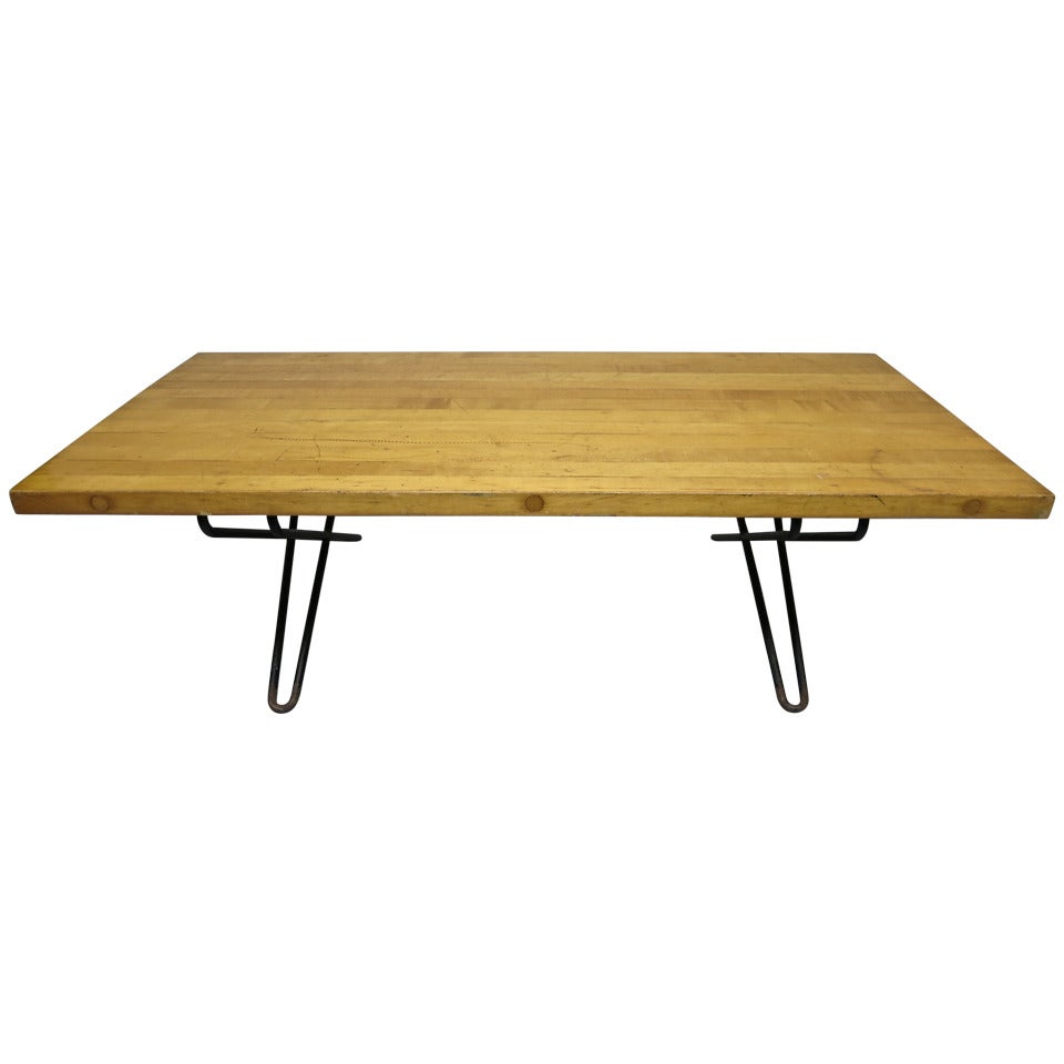 Coffee table with a rectangular wood top that has 13 strips of solid maple set together and joined in three places by a round peg that runs through each piece to form a solid wood top. The peg also acts as a visible detail shown in images 2, 3 and