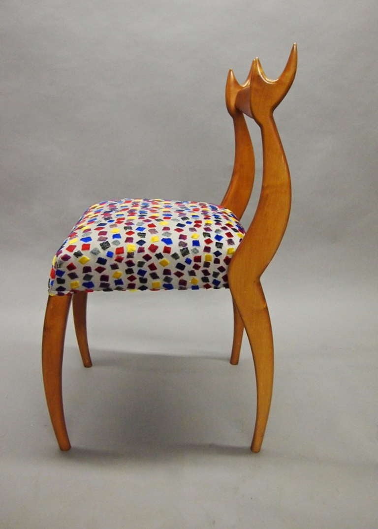 Four 'My Dear Chairs' designed and produced by a NYC SoHo based company founded by Sergio and Monique Savarese. The chairs have seamless, wooden frames and are upholstered in multicolored, geometric patterned fabric.