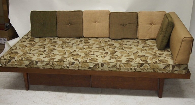 Daybed in wood with metal supporting the back cushions and two drawers at bottom for storage