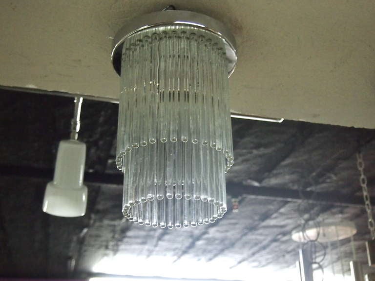 Ceiling fixtures are all original with labels and no chips or cracks to the glass rods. The shorter rods are on the outside surrounding the longer. Still have labels showing cascade name. The lights have a centre socket and can use a 75 watt bulb.
 