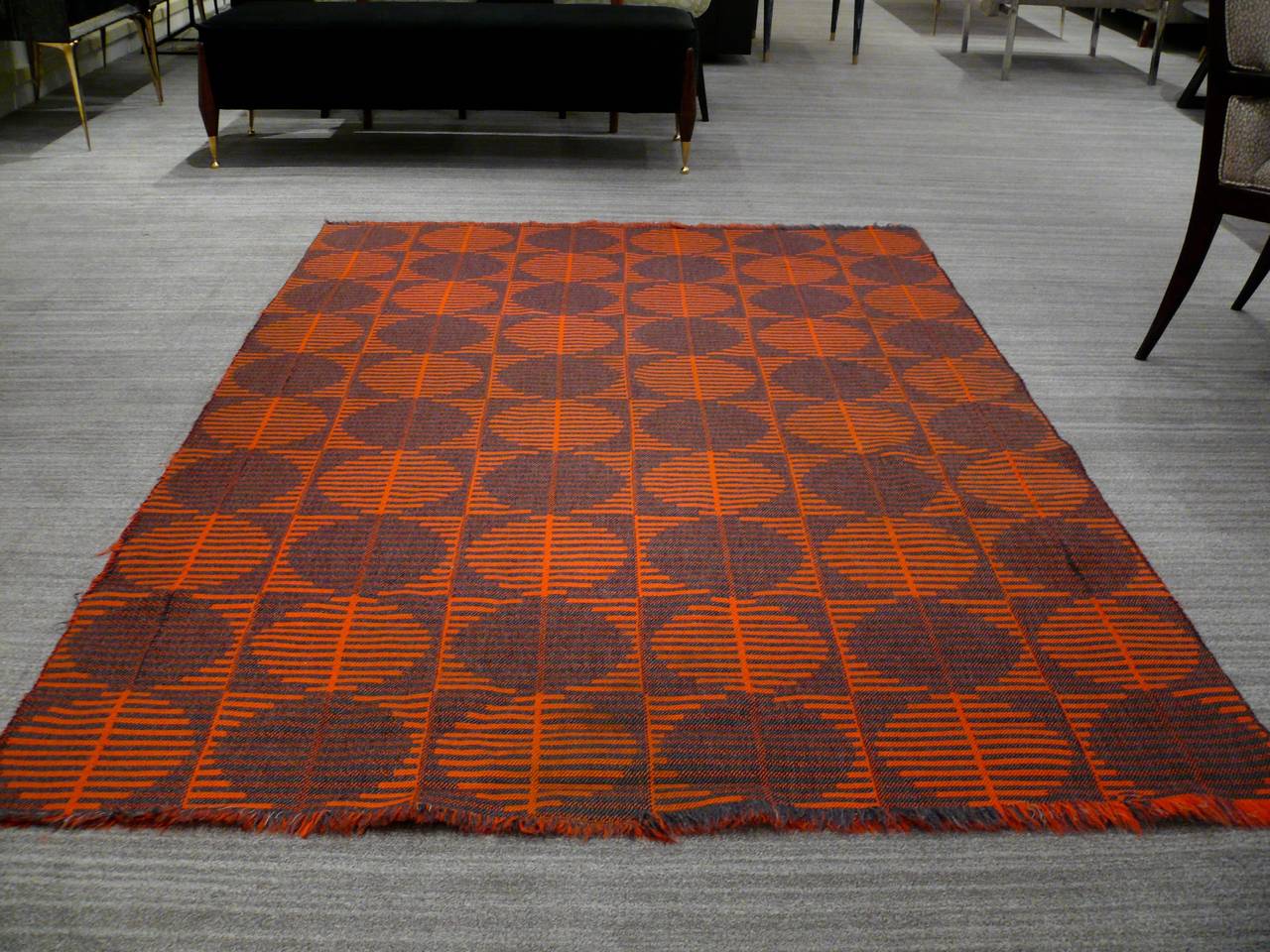 Gorgeous Italian wool rug in the style of Verner Panton with a beautiful mix of orange and charcoal geometric pattern and fringes on both ends.