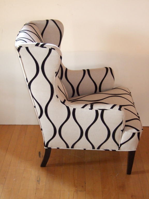 Mid century modern curvy wing chair with added lumbar support @ 1950's.  Legs are newly lacquered in black and newly upholstered in neutral linen with black flocked geometric pattern.  Truly a one of a kind chair!