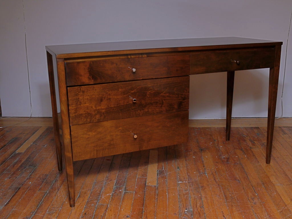 Paul McCobb Planner series desk refinished in natural walnut.  Marvelous grain to the entire piece. 4 drawers in total with ample kneehole for plenty of storage.  

Please visit Fairfield County's largest freestanding destination for Mid-Century
