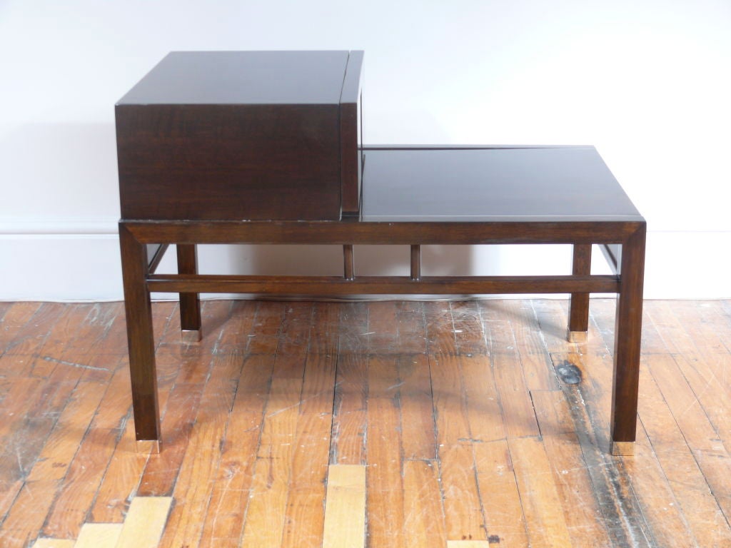 Pair of modernist end tables on chrome sabots.
