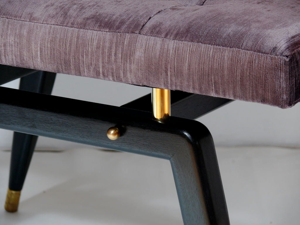 Pair of ebonized sculptural benches with seamed top. Brass sabots, risers and finials.  upholstered in Romo velvet.