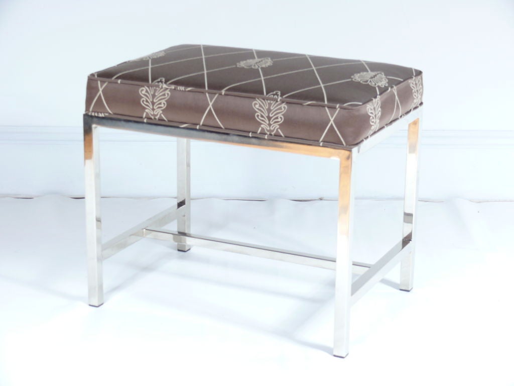 Pair of Mid-Century Ottomans in the style of Milo Baughman. Polished chrome bases with cross stretchers have newly upholstered box cushion tops.

