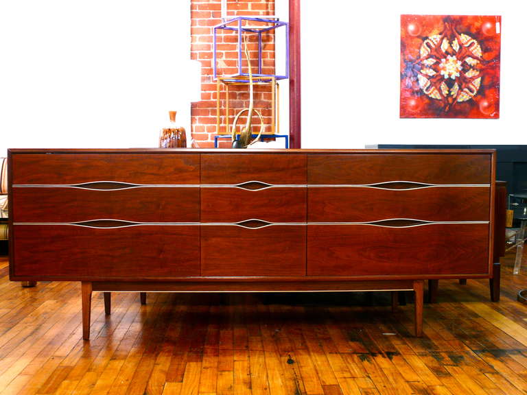 Stunning 9 drawer credenza with chrome banding set upon a floating base
