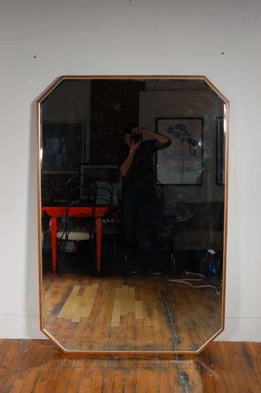 Large Octagonal Mirror by Directional framed in natural Walnut and inlaid with Brass. This could possibly be a custom piece and is of superior quality.   Solid Brass screws hold the frame together and are part of the detail.  This mirror is dated