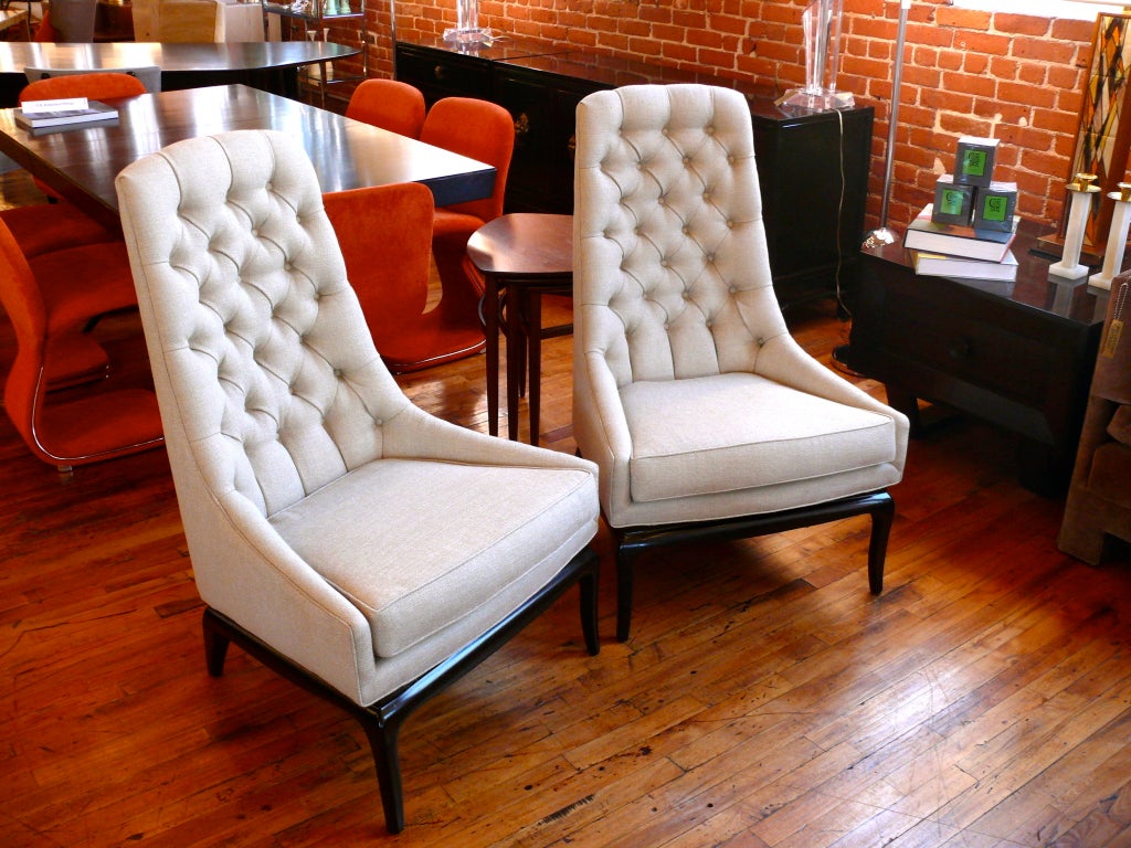 Fabulous pair of mid century high back chairs, beautifully tufted creating a diamond design pattern, seating on a deep chocolate finished wood base.