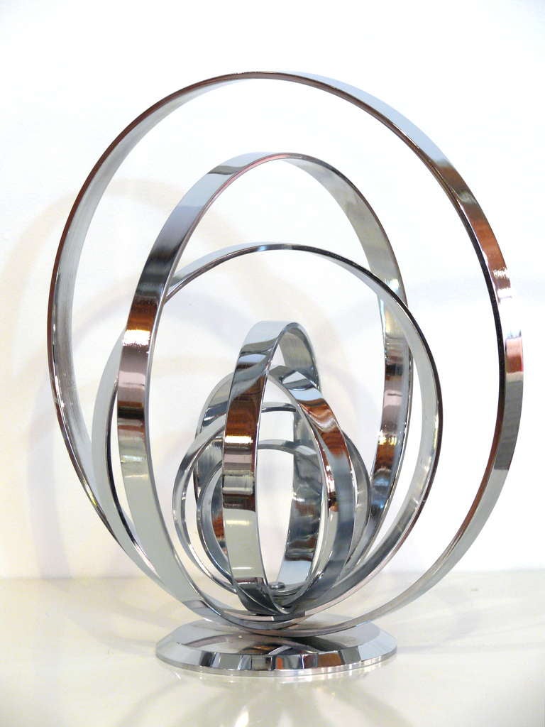 Very solid and extremely weighty chrome armillary sculpture.  Concentric circles of varying diameters compose this sculpture.  Whether on a table or shelf this brilliant accessory will add charm and dimension to any space.  <br />
<br />
