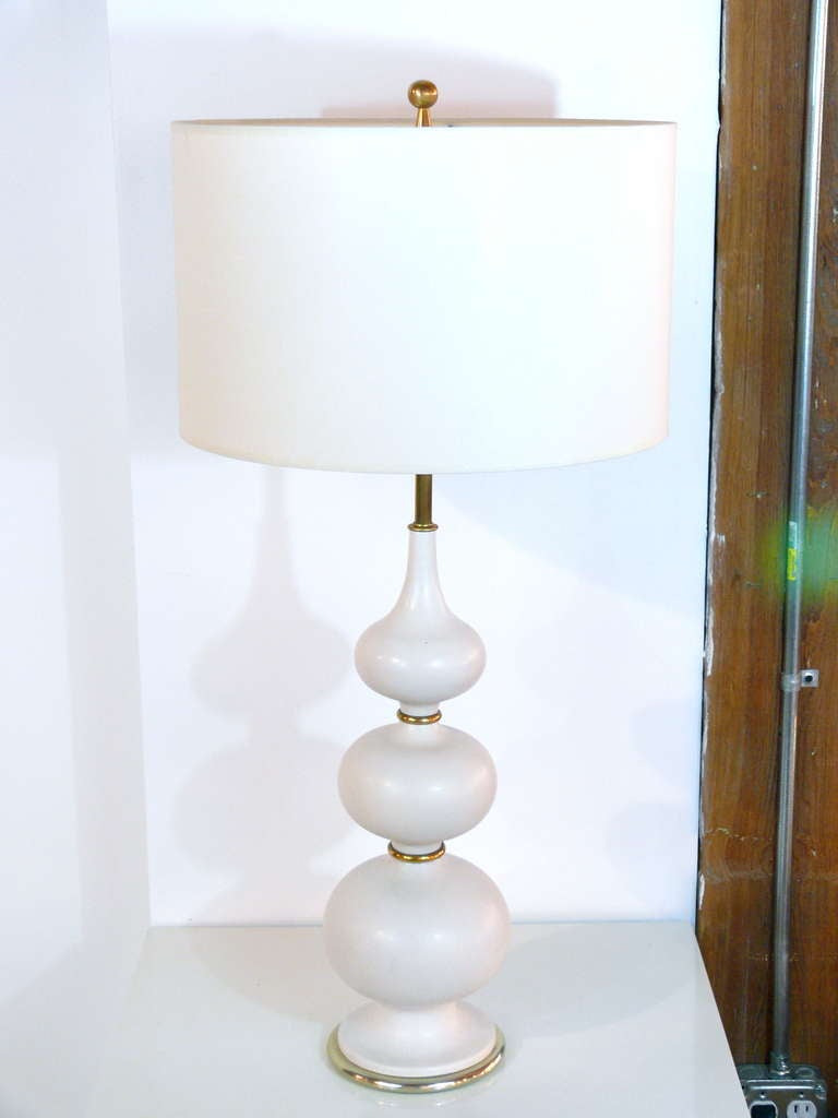 Classic Gerald Thurston white ceramic gourd table lamp with brass accents. This lamp is newly rewired with a three way brass socket. Lamp has original solid brass finial. Shade not included. 

 