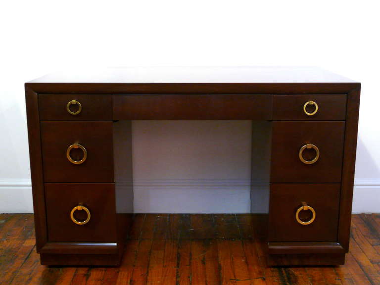 Seven drawer desk by TH Robsjohn Gibbings for Widdocomb.  All original dooorknocer hardware newly polished.  Desk is finished in a deep espresso