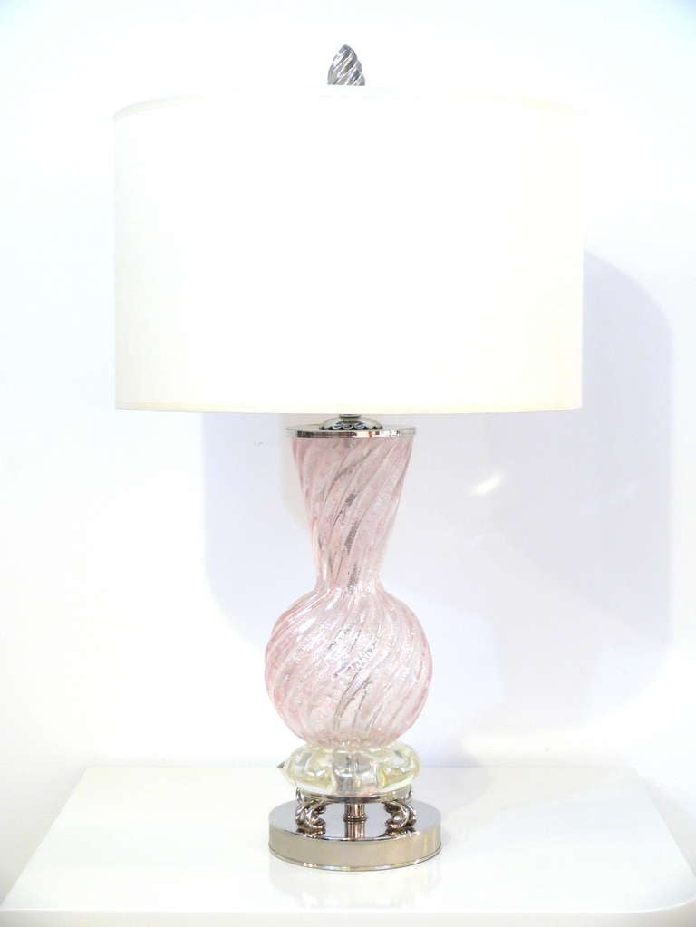 Pair of glass blown Murano table lamps.  The glass body has a soft pink tint resting on sculpted round chrome bases and spiral spear head finials.
