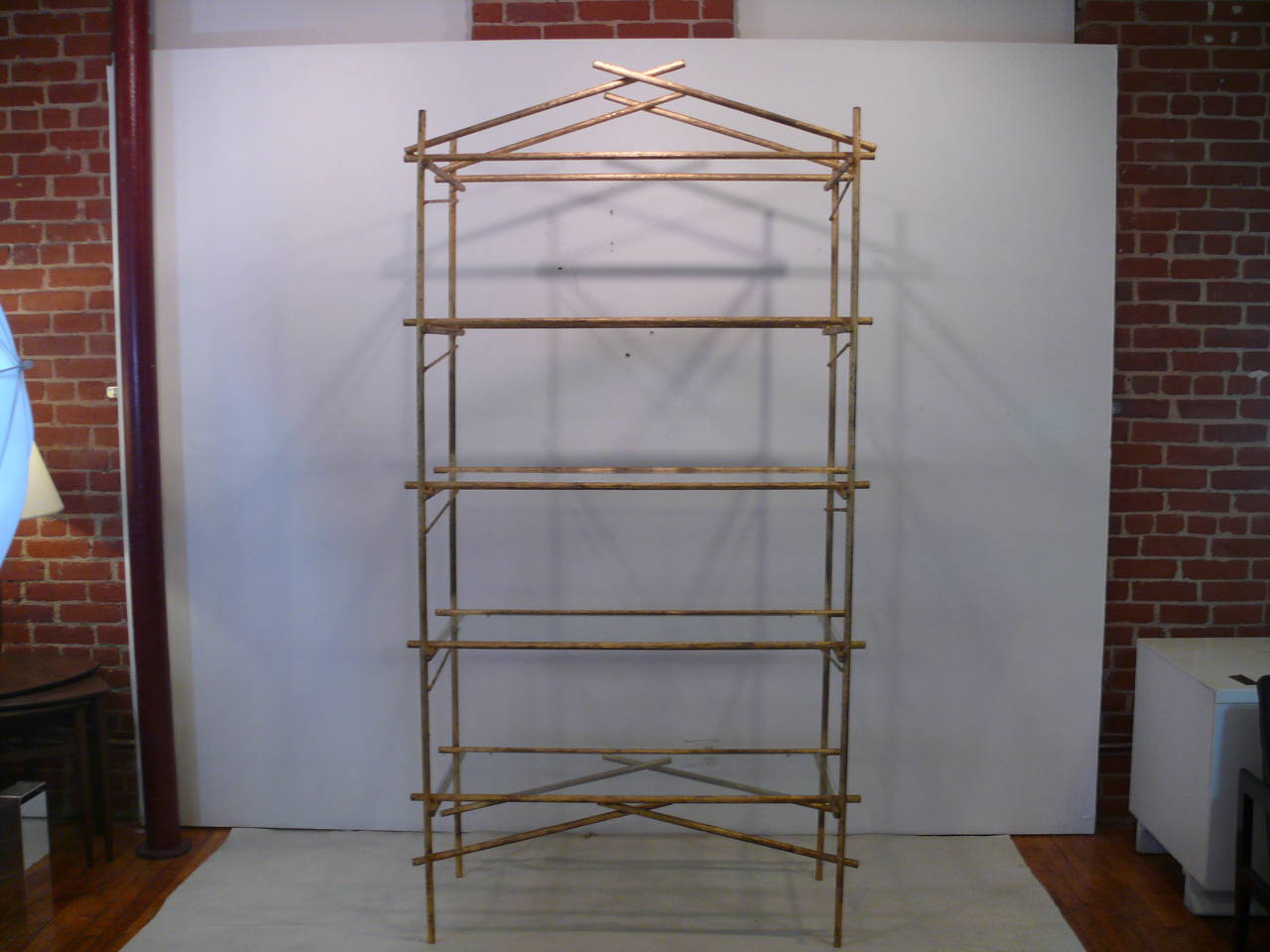 Extra tall 1960s etagere with four glass rectangular shelves. The solid steel piece has a faux wood branch effect as well as a 