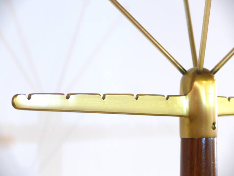 Gorgeous Mid-Century brass coat stand in the manner of Gio Ponti. It carries beautiful brass ball-end hanging stems and the wood sections have been refinished in a rich semi-gloss natural walnut.