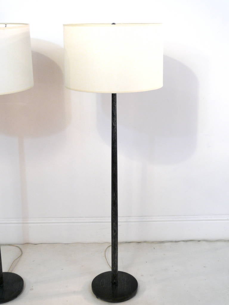 Pair of Swedish oak floor lamps finished in a black ceruse. Round base and tapered stem. Newly refinished and rewired with three-way socket. 

Shades not included.
