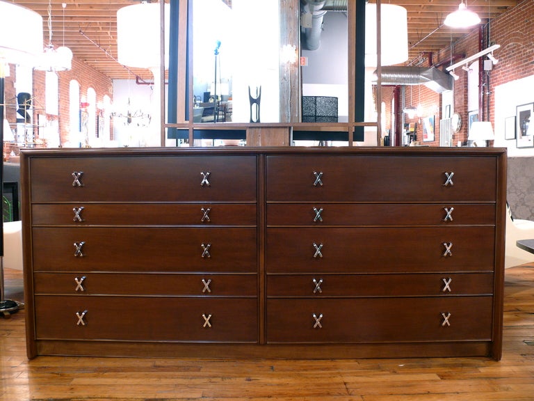 Classic pearwood Paul Frankl ten-drawer dresser/credenza newly stained in natural walnut. All hardware newly polished and plated in nickel.