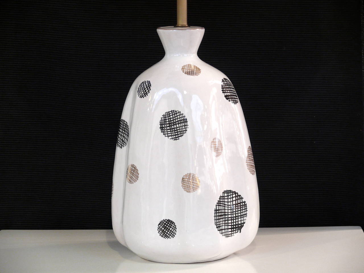 Pair of white glaze ceramic lamps by Raymor Pottery with stylish polka-dot sketch design and brass three-way sockets and accents.

Shades not included.