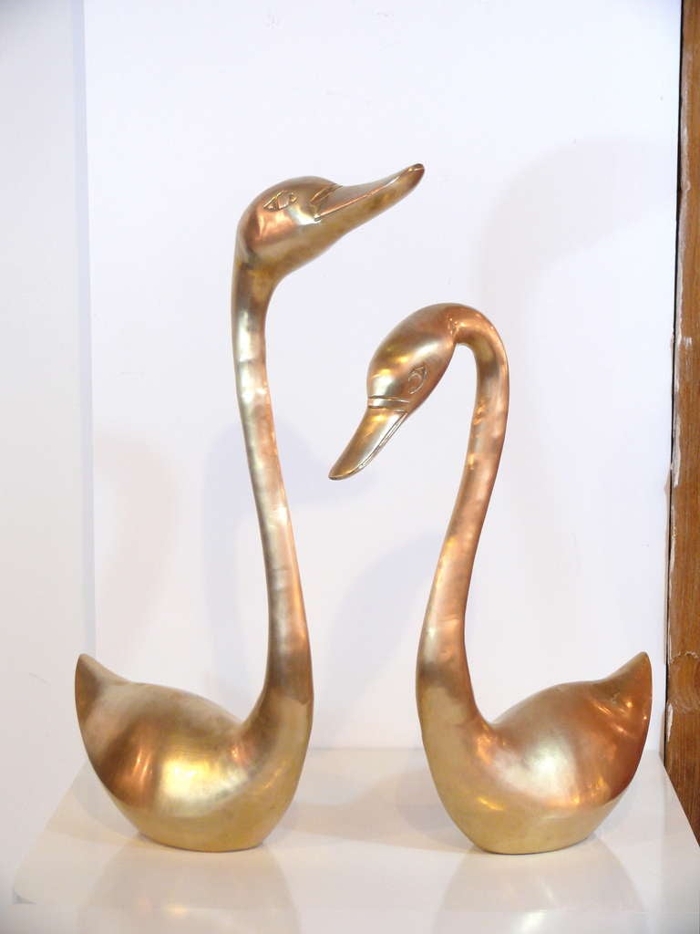 Pair of mid-century brass sculptural swans.