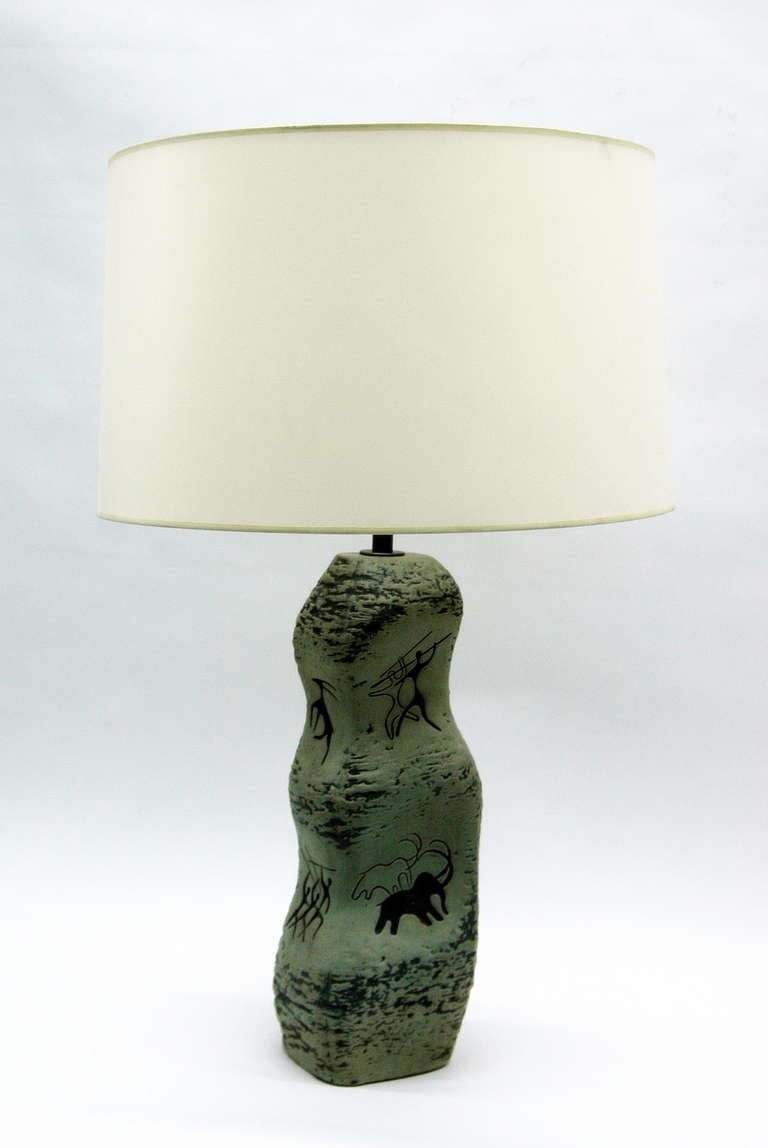 Vintage ceramic table lamp with Lascaux-style depictions of pre-historic hunters and their prey. Excellent texture and naturalistic stone coloring. Perfect for a ski chalet or country retreat.