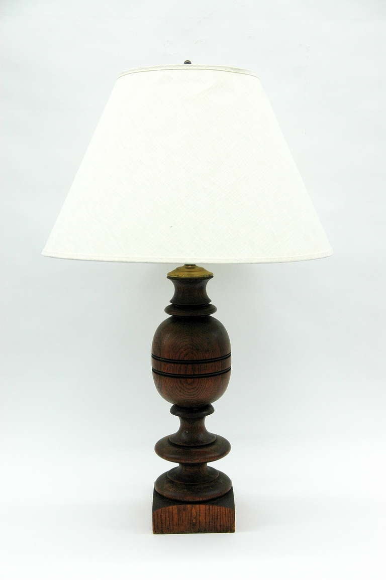 The turned wood lamp on a pedestal base.