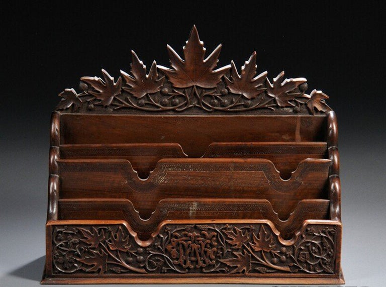 Beautiful letter box, elaborately carved throughout with scrolling oak branches and leaves, with central monogram to front and four letter slots. A one of a kind carving masterpiece.