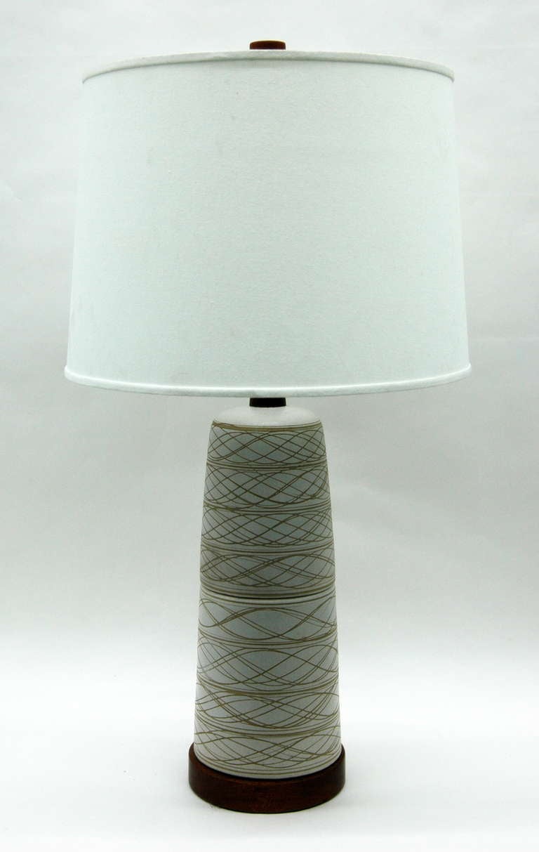 A ceramic table lamp by Gordon and Jane Martz for Marshall Studios. The piece has the signature wood accents on the base and the neck and includes the original wood finial. Lampshade not included.