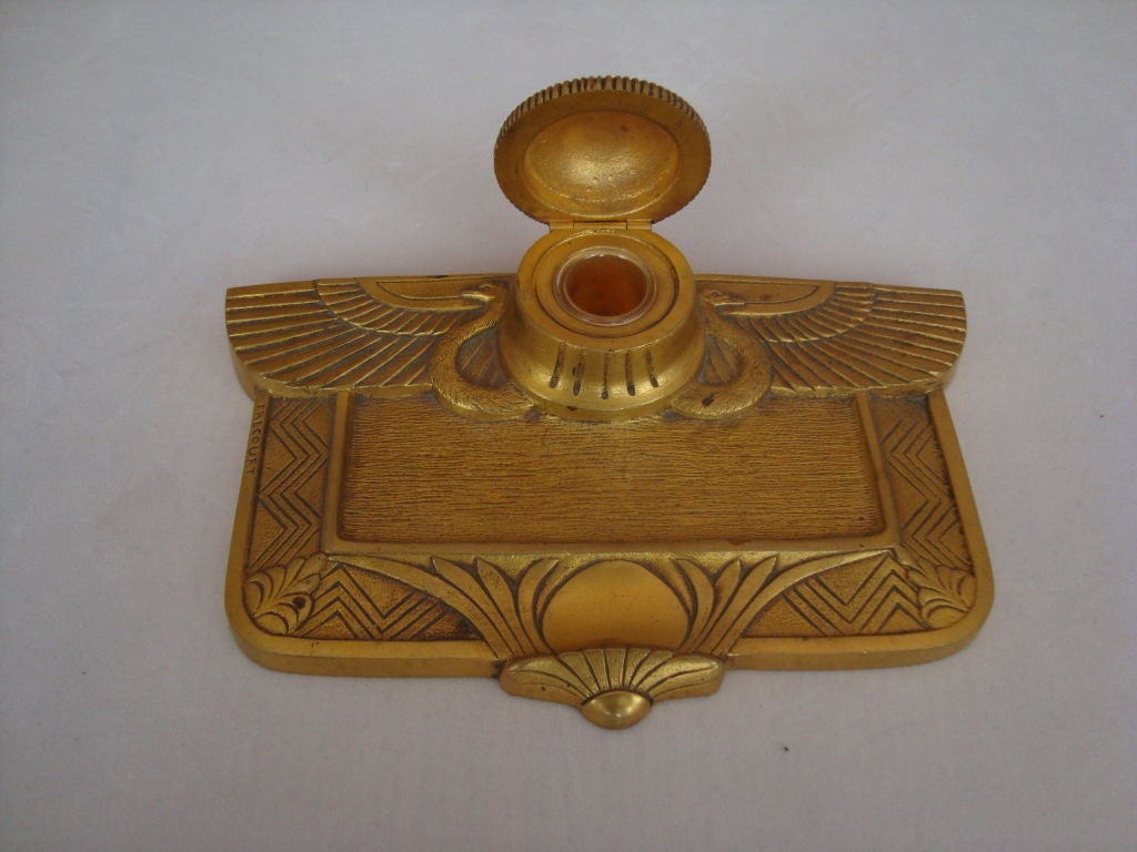 Gilt bronze inkwell with Egyptian revival decorative motifs - this recursion of the style inspired by the discovery of Tutankhamen's tomb by a Howard Carter-led team of Egyptologists and archaeologists.

Art Deco period, probably early 1920s.