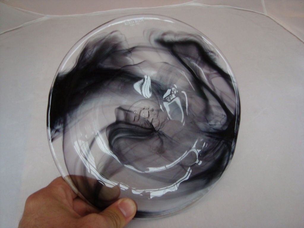 An interesting glass plate infused with a color to give the appearance of smoke drifting, stamped by the maker what appears to be WU HV.Kosta Boda 