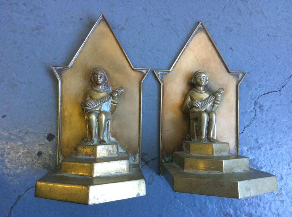 A well crafted pair of bookends with seated men playing a mandolin, possibly a sitar.