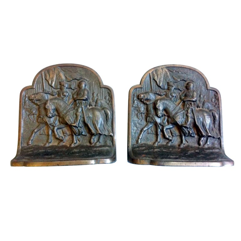 A set of heavy Bronze bookends depicting knights in armor marching into battle.