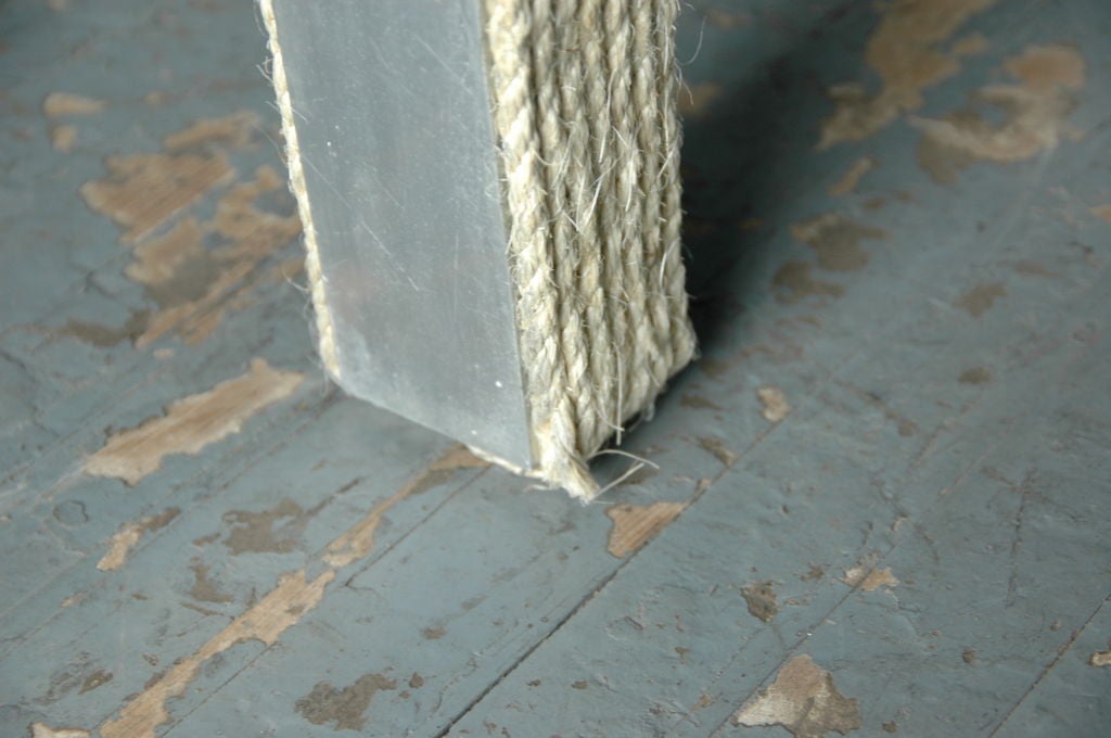 Rope An unusual rope wrapped metal table base and glass top