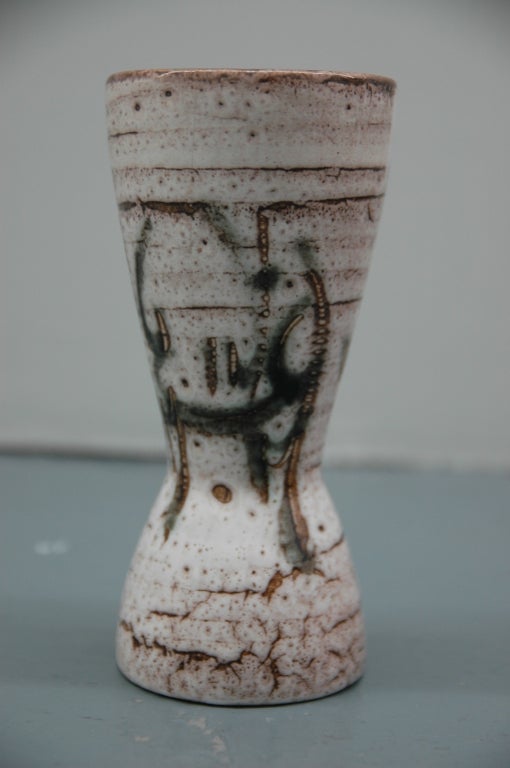Waisted studio pottery vase with irregular off-white glaze with black abstract decoration.

Labeled on base with incised mark reading:
